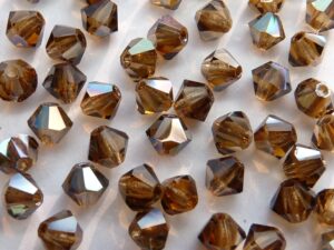 04-MC-10220-22501 Bicone, Smoke Topaz Celsian 4 mm. 50 Pc.-0