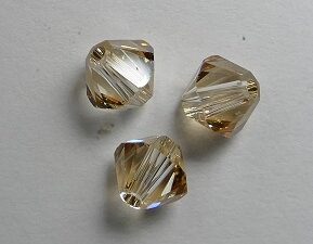 SW-05-CGS 5328 Crystal Golden Shadow Swarovski Bicone 5 mm. 10 Pc.-0