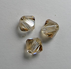 SW-05-CGS 5328 Crystal Golden Shadow Swarovski Bicone 5 mm. 10 Pc.-0