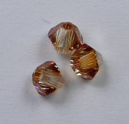 3 mm Crystal Metallic Sunshine Swarovski Element Bicones - Afbeelding 1