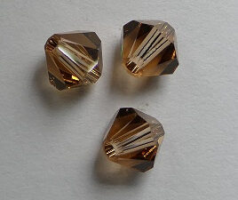 SW-05-SMTOLT 5 mm Light Smoked Topaz Swarovski Element Bicones - Afbeelding 1