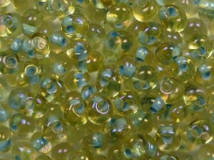 TM-03-0952 Inside Color Rainbow Light Topaz-Sea Foam Lined Magatama 3 mm. TOHO (kopie)